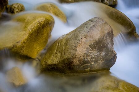 landscape with wet stones in run of mountain brookの写真素材