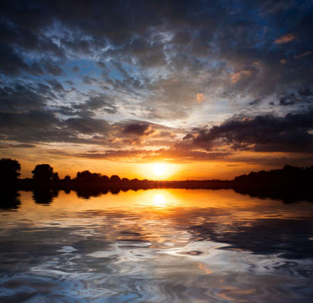 Nice sunset sky over water surfaceの写真素材