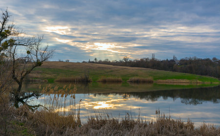 Spring sunset over wild lakeの写真素材