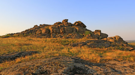 old stones in evening steppe. Famouse stone grave place in Ukraine.の写真素材