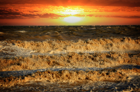 Red sunset over stormy sea. Azov sea in Ukraineの写真素材