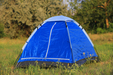 nice blue tourist tent on grasslandの写真素材