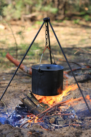 smoked tourist kettle over fire in forestの写真素材
