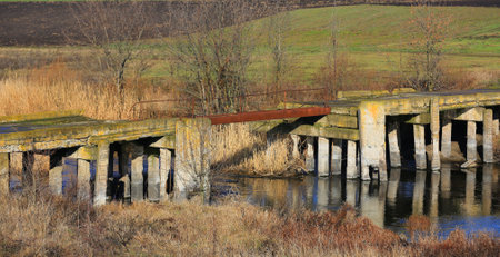 ruine of old bridge over riverの写真素材