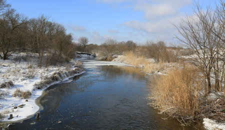 Winter landscape with river in forestの写真素材