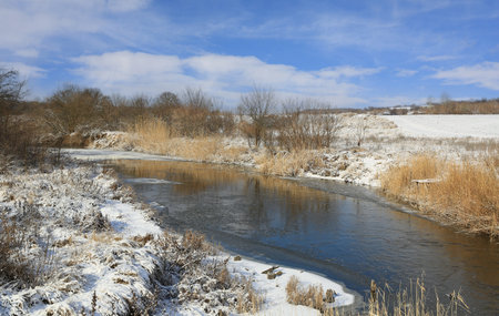 winter rural landscape with small riverの写真素材