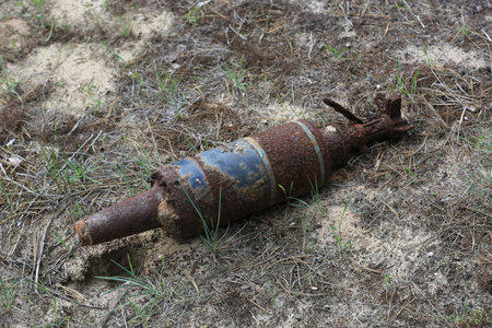 old dangerous unexploded ordnance on the groundの写真素材