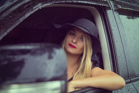 Portrait of a beautiful young woman driving a carの写真素材