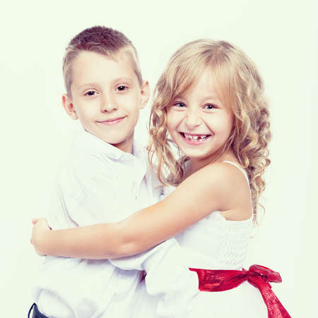 Portrait of beautiful smiling boy and a girlの写真素材
