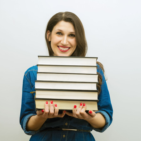 Attractive cheerful woman with booksの写真素材