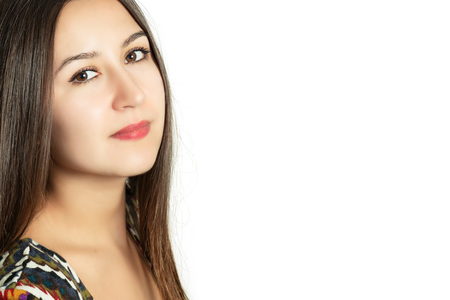 Portrait of a beautiful young girl on a white backgroundの写真素材
