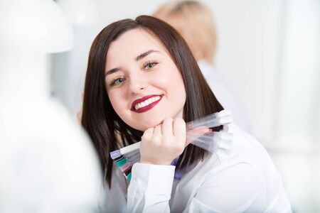 Portrait of a beautiful young woman at a workplace in a beauty salon. Manicuristの写真素材