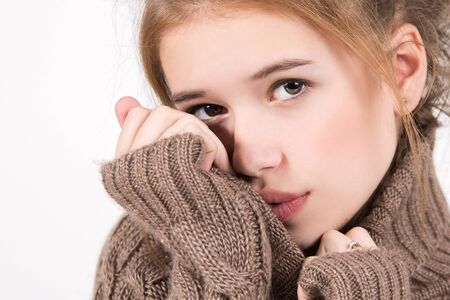 Portrait of a beautiful young girl on a light background. Female face closeup
