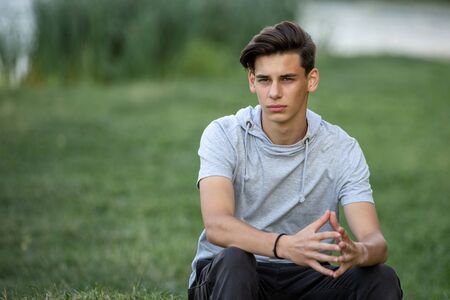 Portrait of a young handsome man outdoors. Teenager