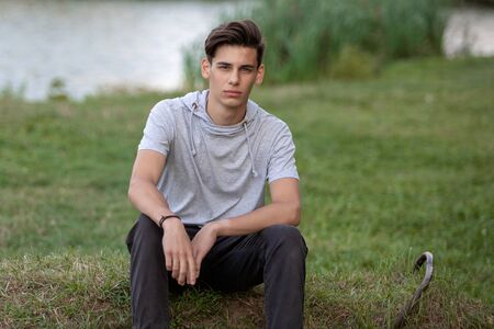 Portrait of a young handsome man outdoors. Teenagerの写真素材