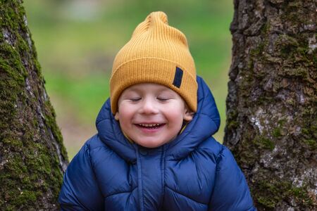 Portrait of a child outdoors. Happy little boyの写真素材