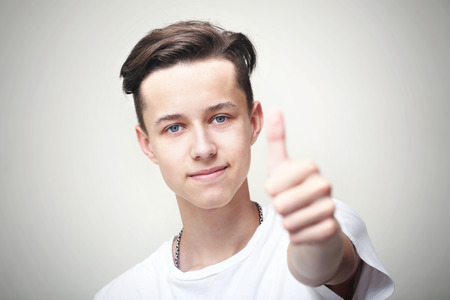 Young man showing thumbs upの写真素材