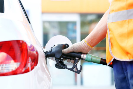 Hand refilling the car with fuel. Refuel stationの写真素材