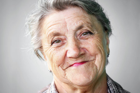 Smile granny face on gray background. Grandmotherの写真素材