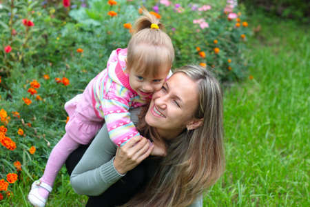 Happy Mom and daughter in the gardenの写真素材