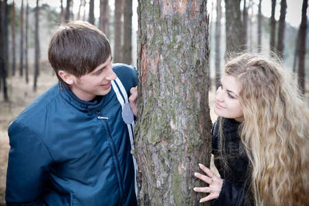 beautiful young couple smiling together in forestの写真素材