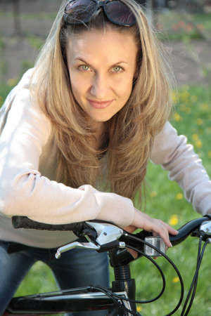 Outdoor shoot of young woman with bicycleの写真素材
