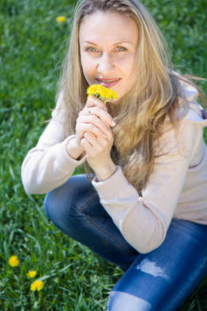 Young beautiful woman in spring field 