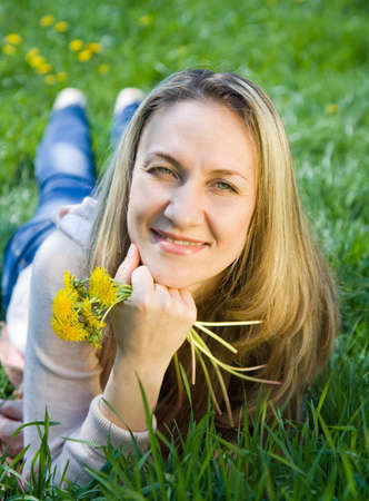 Young beautiful a woman in spring fieldの写真素材
