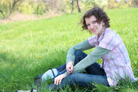 A young attractive girl listening to music in the parkの写真素材