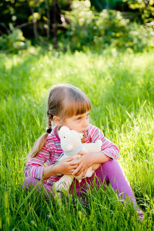  A sad little girl alone on outside the homeの写真素材