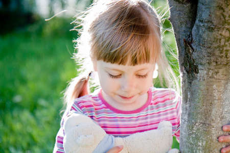 A sad little girl alone on outside the homeの写真素材
