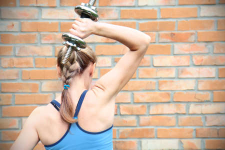 A young woman in sport wear exercising in sport clubの写真素材