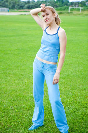 Relax in grass - tired woman after sport の写真素材