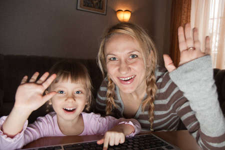 Mother and daughter talking in the Internet at homeのeditorial素材