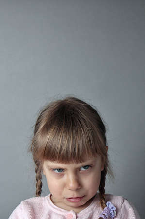 A very distraught girl on a gray background の写真素材