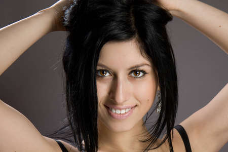 Portrait of beautiful sexy brunette on a gray backgroundの写真素材