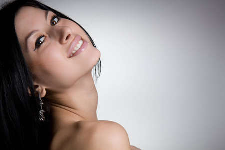 Portrait of beautiful sexy brunette on a gray backgroundの写真素材