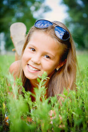 Portrait of a smiling girl on the grass の写真素材