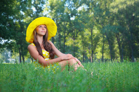 The girl in a hat on natureの写真素材