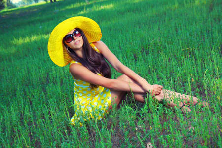 The girl in a hat on nature の写真素材
