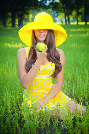 The girl in a hat on nature の写真素材