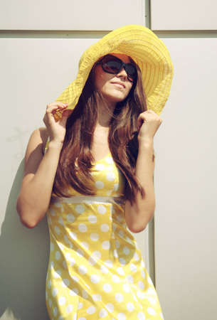 Beautiful girl in a yellow hatの写真素材