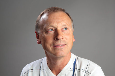 Portrait of a mature man on a gray background.の写真素材
