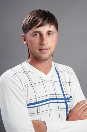 Portrait of a young man on a gray background.