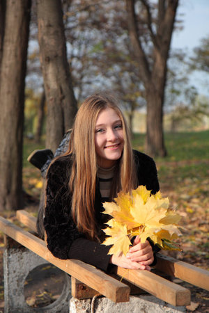 Smiling girl in autumn parkの写真素材