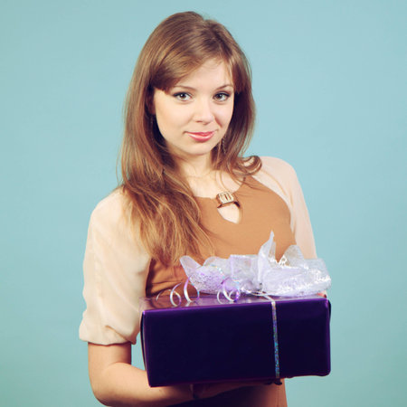 A beautiful girl with a gift.の写真素材
