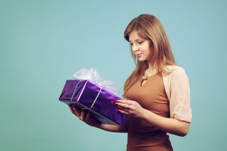 A beautiful girl with a gift.の写真素材