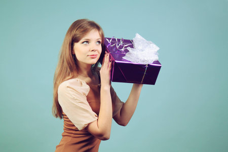 A beautiful girl with a gift.の写真素材