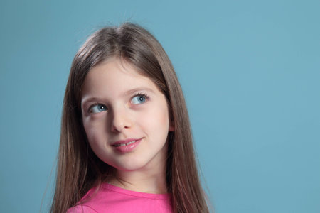 Portrait of a beautiful girl on a blue background の写真素材