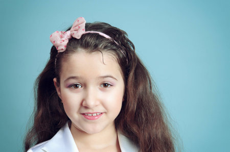 Portrait of a beautiful girl on a blue background.
